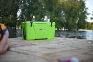 Lime Green Kenai Cooler sitting on edge of dock