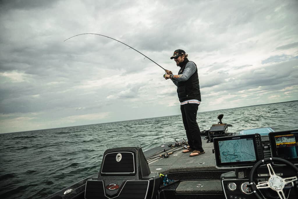 Matt Peters Walleye Fishing On Bow Of Boat In Open Water