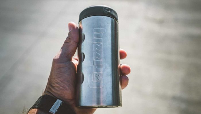 grizzly coolers drinkware, slim can koozie in palm of a hand